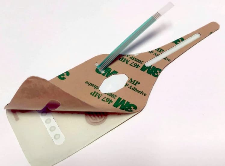 Screen adhesive partially peeled, showing contact pads